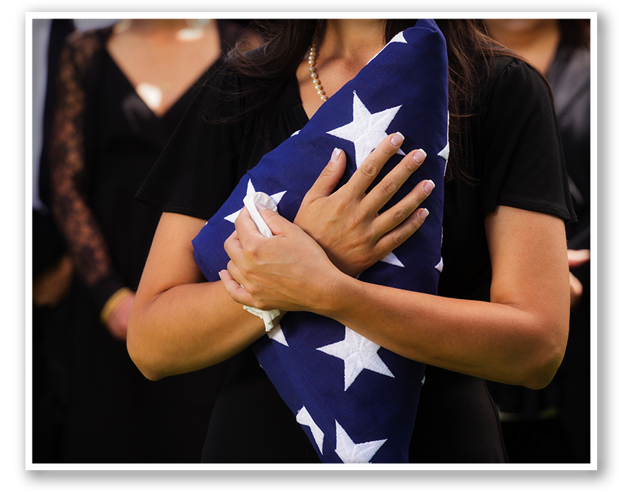 Woman in black holding a tri-folded flag and tissue