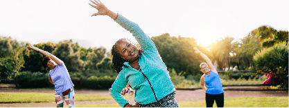 Woman stretching during an outdoor group fitness class